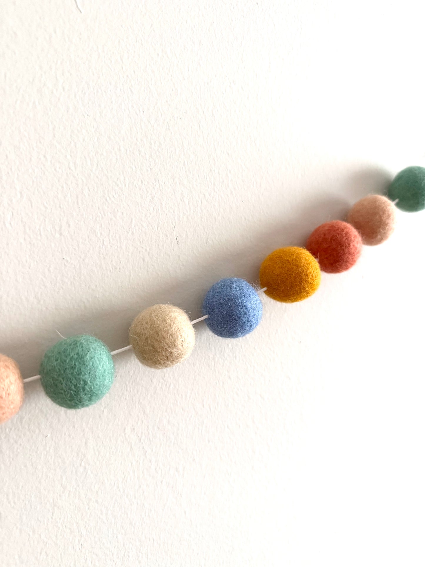 Muted rainbow felt ball garland