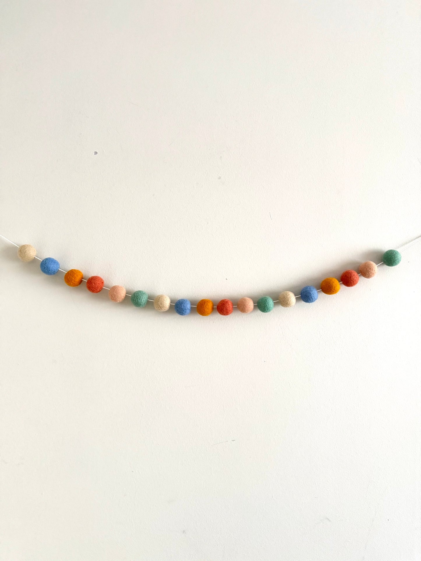 Muted rainbow felt ball garland